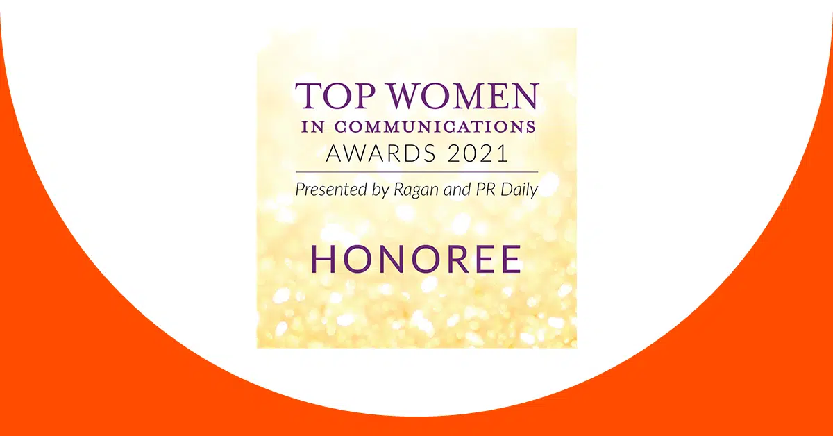 A graphic shows a gold and white background with text in the center. The text reads, “Top Women in Communications Awards 2021. Presented by Ragan and PR Daily. Honoree.” The upper and lower edges of the image are curved and are colored in orange, creating a white circular area in the middle.